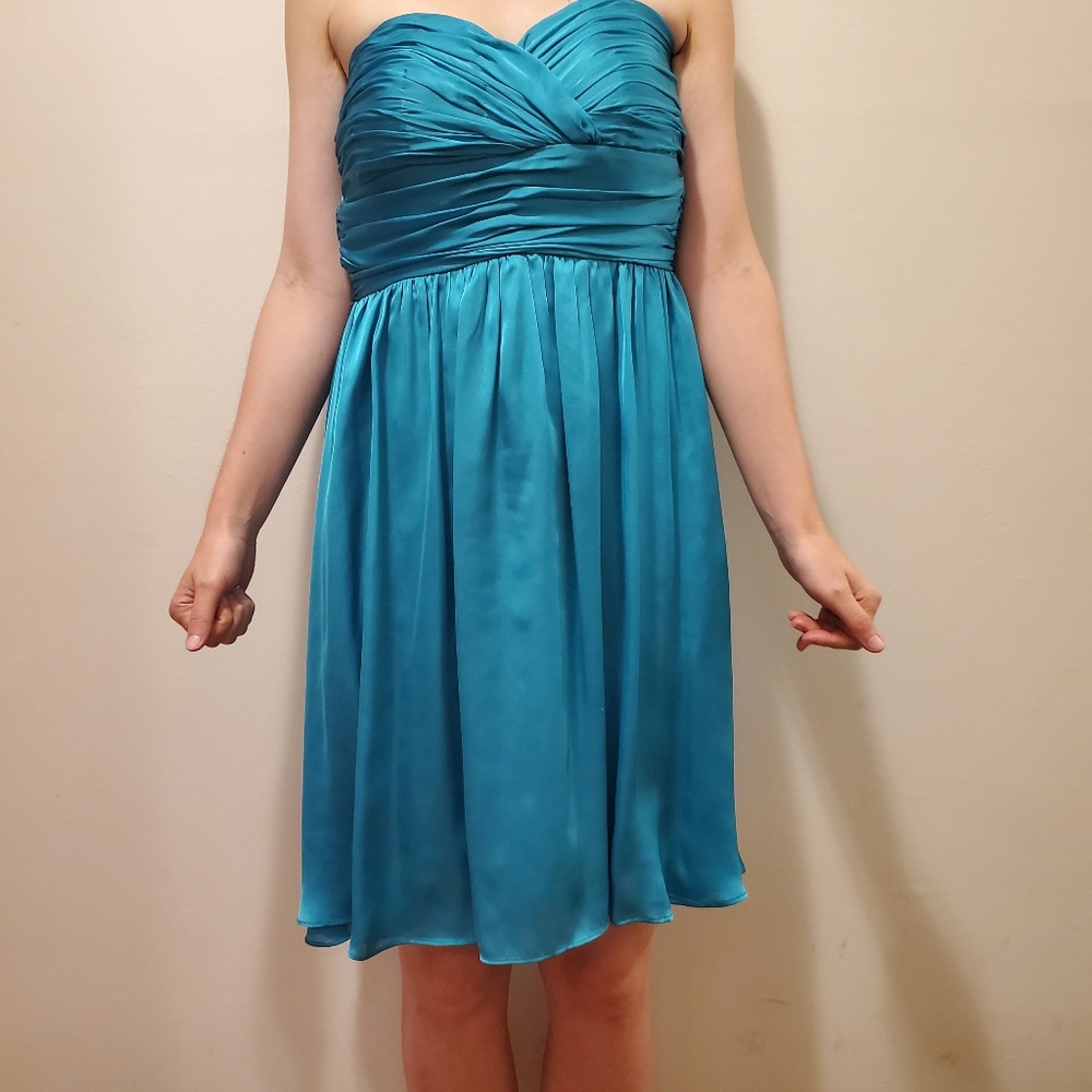 Emerald green strapless dress with a hint of blue.  Size is Small